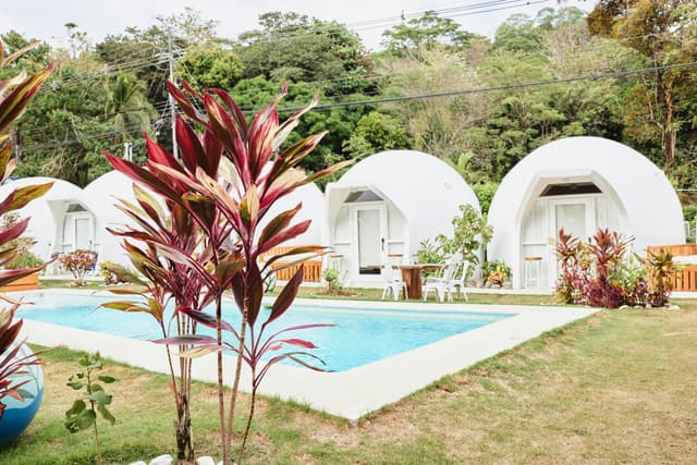 Holidaze featured Home: The Dome Hotel - A lovely beach hotel with dome apartments by the pool. Enjoy the tropical setting with a cocktail while lounging in the sun